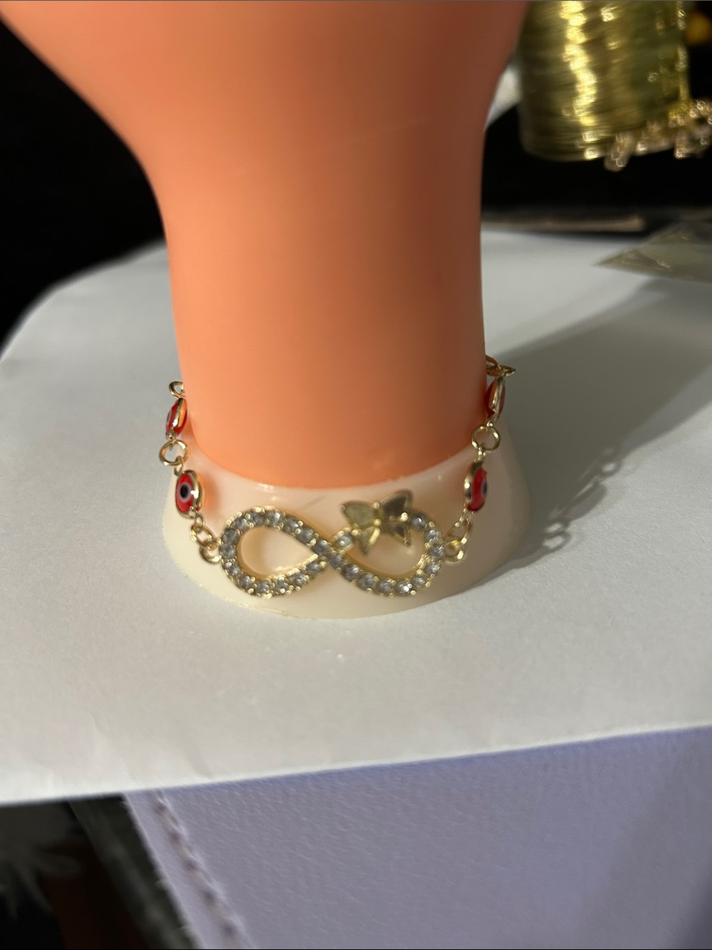 Gold Infinity Bracelet with Red Eye Charms